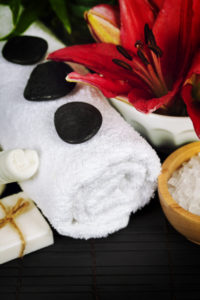 Spa concept (flowers, towel, sea salt and massage stones)